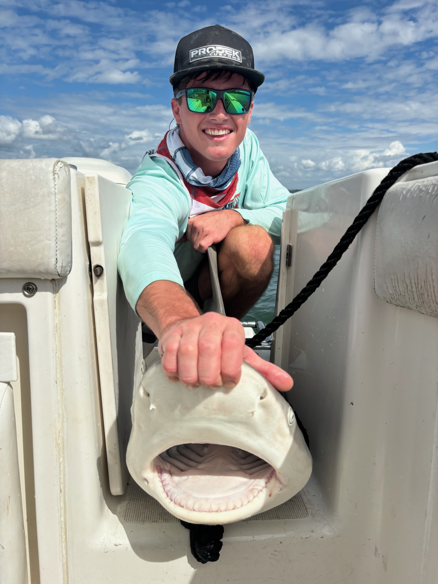 Angler with bull shark on Galveston offshore fishing charter